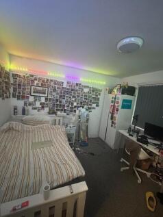 A cozy double bedroom featuring a vibrant photo...