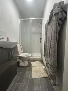 A modern bathroom featuring a shower and stylis...