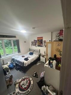 A spacious double bedroom with ample room for p...