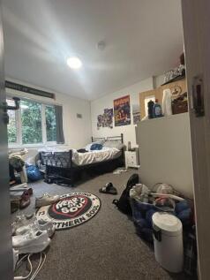 A spacious double bedroom with ample natural li...