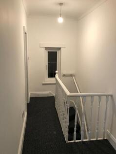 A clean and well-maintained hallway with a brig...