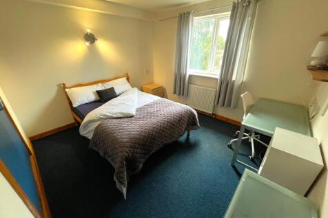 A spacious and inviting double bedroom featurin...
