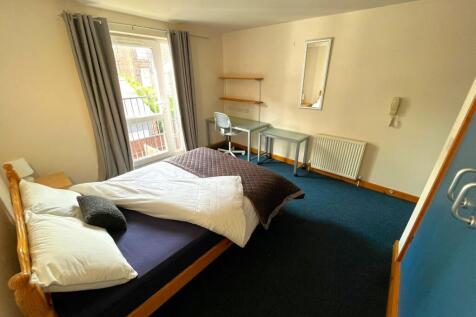 A spacious and well-lit double bedroom featurin...