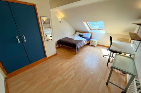 A bright and spacious double bedroom featuring ...