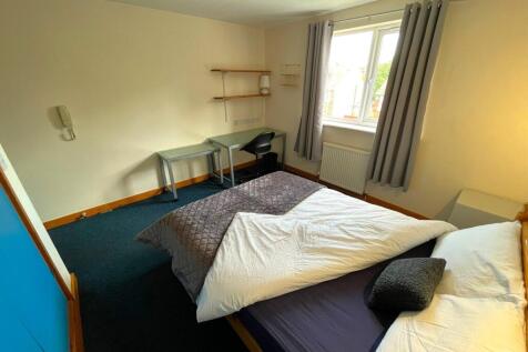 A spacious and well-lit double bedroom featurin...