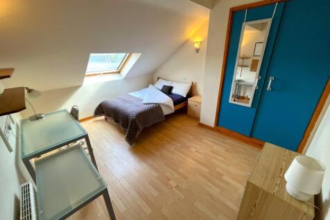 A bright and inviting double bedroom with ample...