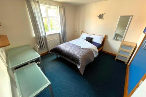 A bright and inviting double bedroom featuring ...