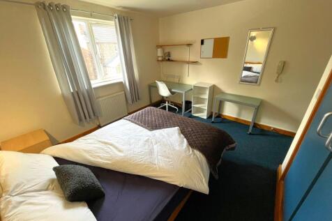 A bright and spacious double bedroom featuring ...