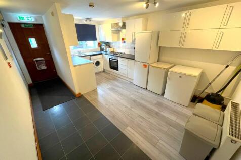 A bright and modern kitchenette with ample stor...
