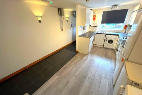 A spacious and modern kitchenette equipped with...