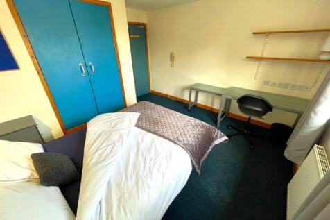 A cozy double bedroom featuring practical furni...