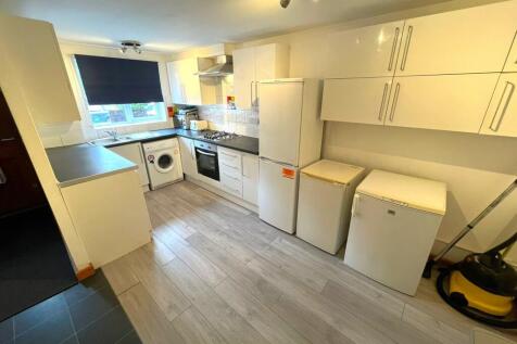 A spacious and modern kitchenette equipped with...
