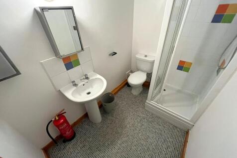 A well-maintained bathroom featuring a shower a...