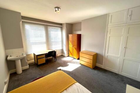 A spacious and bright double bedroom featuring ...