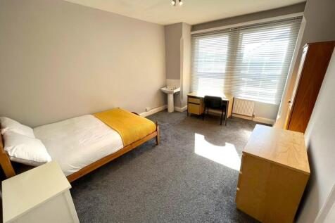 A spacious and bright double bedroom with natur...