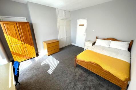 A bright and inviting double bedroom with ample...