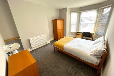 A bright and spacious double bedroom featuring ...
