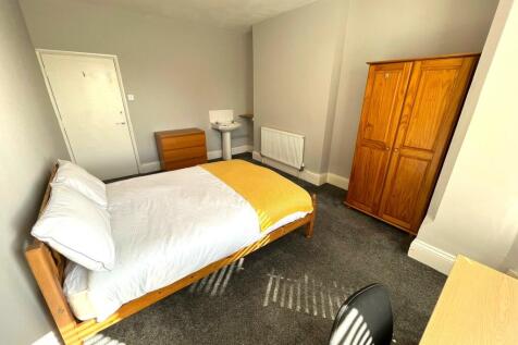A bright and spacious double bedroom with moder...