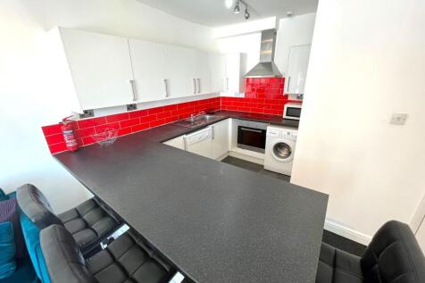 A modern and stylish kitchenette featuring a sl...