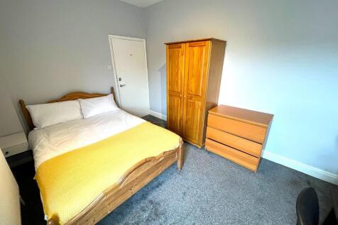 A bright and cozy double bedroom featuring a co...