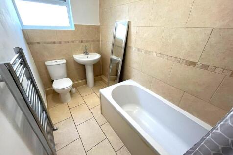 A clean and bright bathroom featuring modern fi...