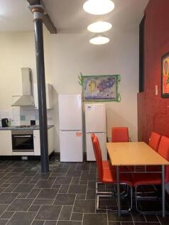 A spacious and inviting kitchenette with modern...