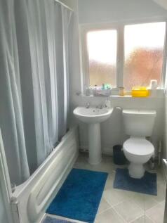 A bright and tidy bathroom featuring modern fix...