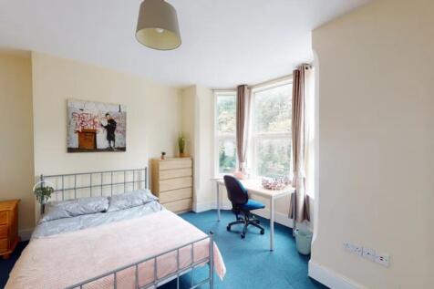 A bright and spacious double bedroom featuring ...