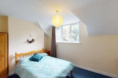 A bright and welcoming double bedroom featuring...