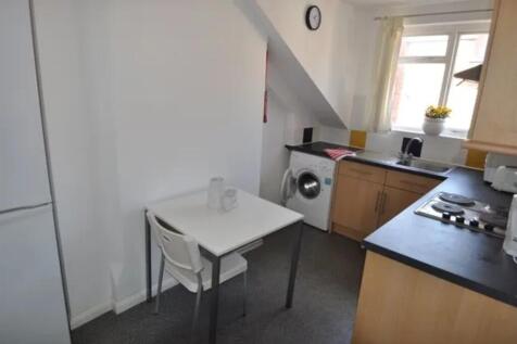 A bright and tidy kitchenette with modern appli...