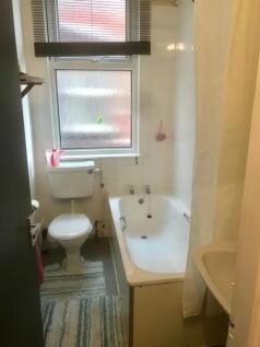 A tidy bathroom with a bath and good natural li...