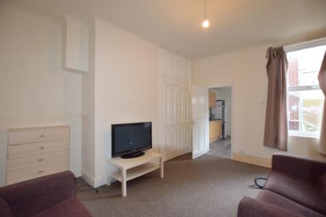 A cozy living room with ample natural light, pe...