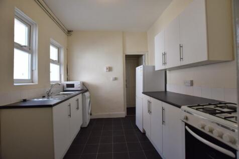 A spacious and tidy kitchenette with ample stor...