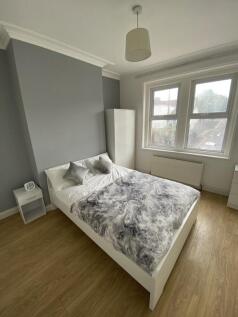 A bright and spacious double bedroom featuring ...