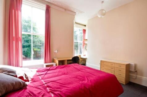 A bright and spacious double bedroom featuring ...
