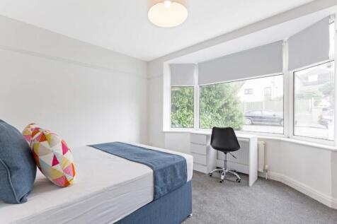 A bright and inviting double bedroom with styli...