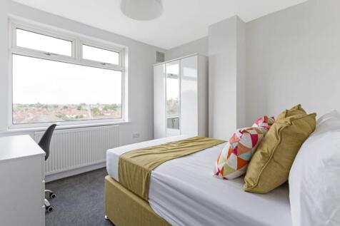 A bright and spacious double bedroom featuring ...