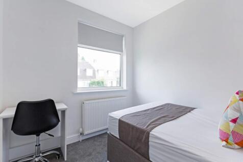 A bright and tidy double bedroom featuring a co...