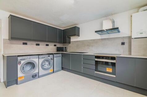Modern kitchen featuring sleek cabinetry, high-...