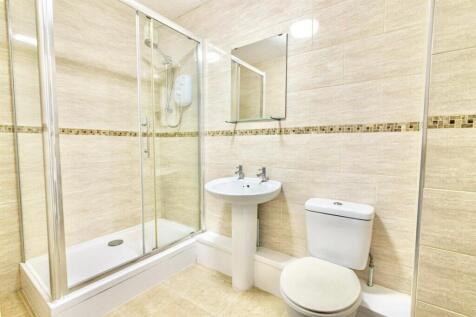A modern bathroom featuring a spacious shower, ...