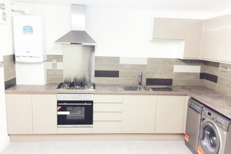 Modern kitchen featuring sleek cabinetry, ample...