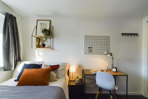 A bright and inviting double bedroom with moder...