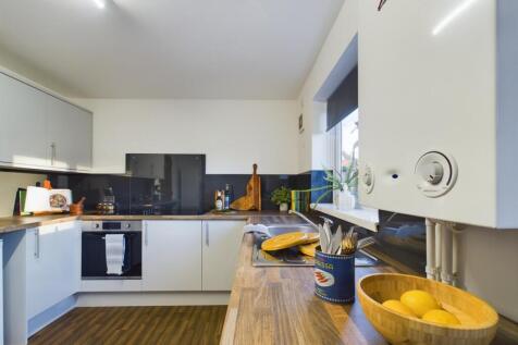 A bright and clean kitchenette with modern appl...
