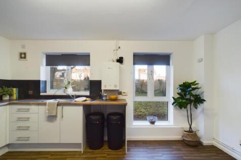 A bright and tidy kitchenette with modern appli...