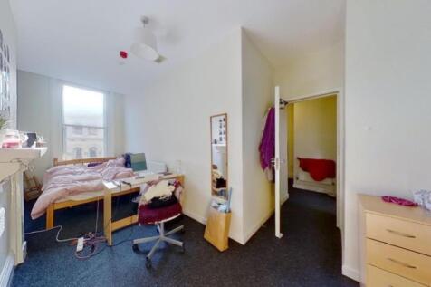A well-lit and inviting double bedroom with amp...