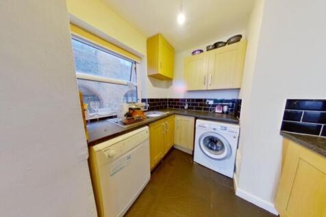A bright and tidy kitchenette with modern appli...