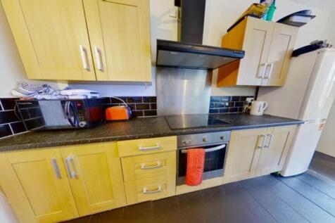 A modern kitchenette featuring ample storage an...