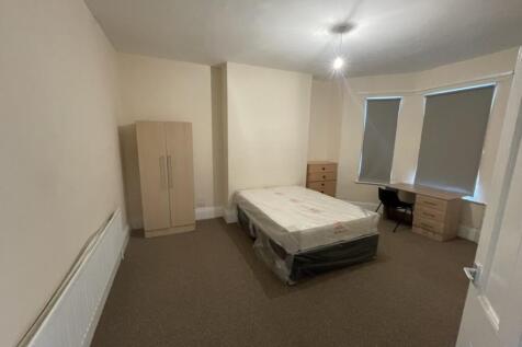 Spacious double bedroom featuring a comfortable...