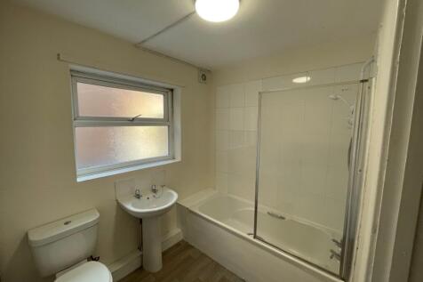 Bright and spacious bathroom featuring a bathtu...