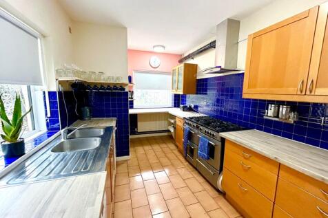 Spacious kitchen featuring modern cabinetry, am...